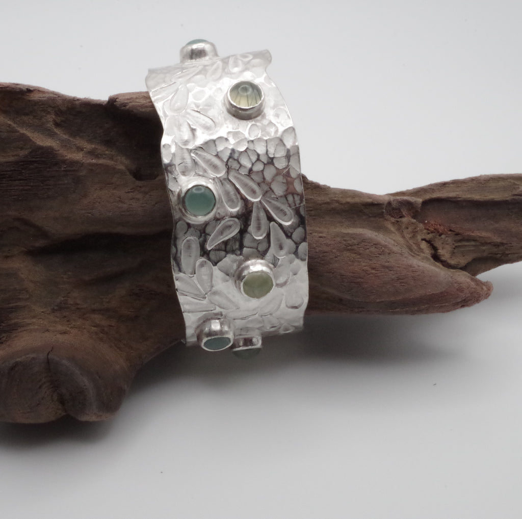 This reclaimed Sterling Silver forged and stamped bangle with rutilated quartz and chalcedony cabochons with flowing waterweed design is inspired by Kent Chalk Streams. It is hand stamped using tools made by me from vintage reclaimed tool steel.

