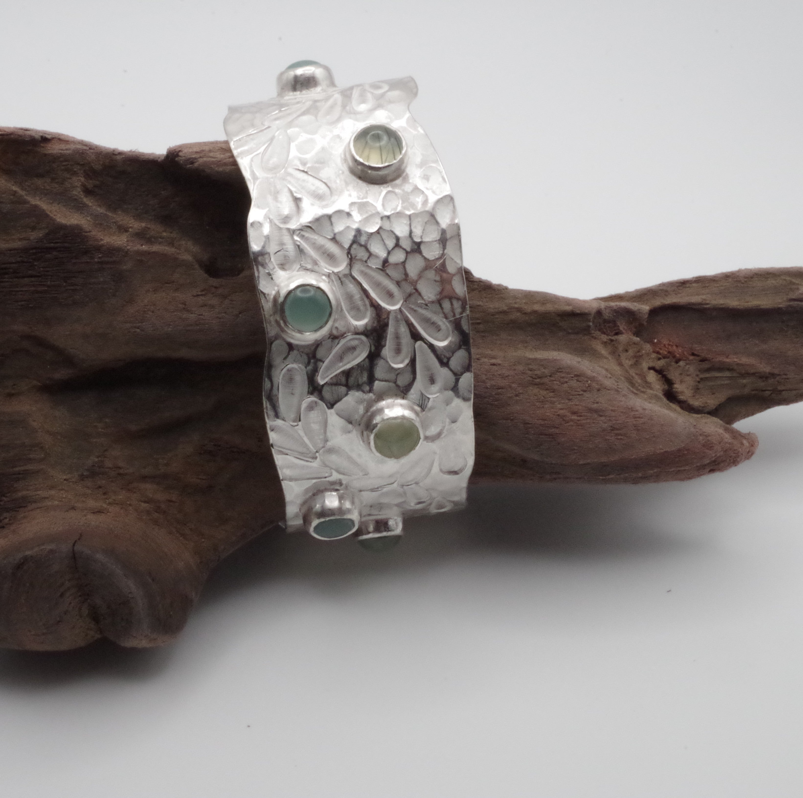 This reclaimed Sterling Silver forged and stamped bangle with rutilated quartz and chalcedony cabochons with flowing waterweed design is inspired by Kent Chalk Streams. It is hand stamped using tools made by me from vintage reclaimed tool steel.

