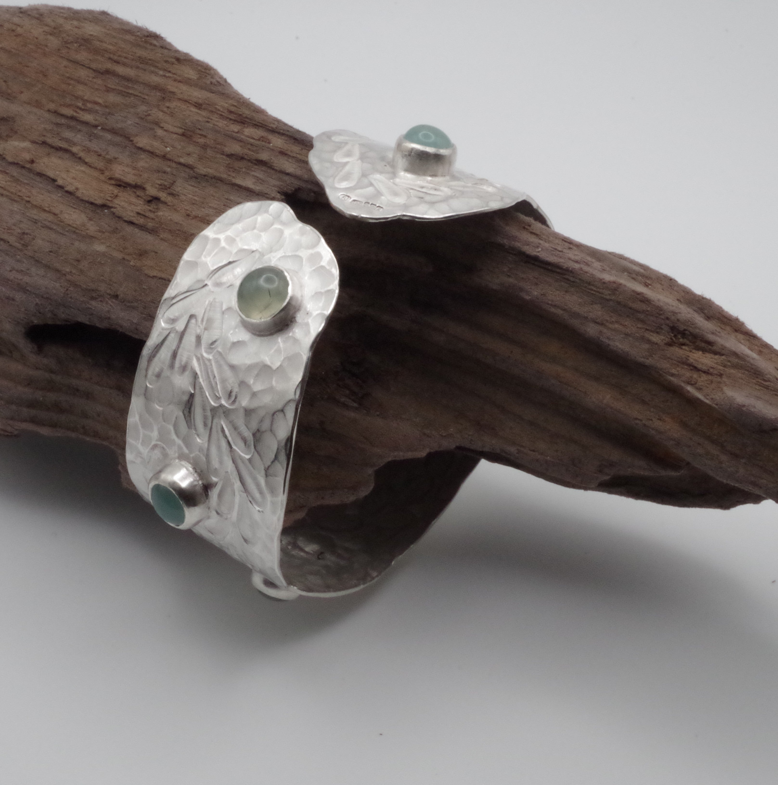 This reclaimed Sterling Silver forged and stamped bangle with rutilated quartz and chalcedony cabochons with flowing waterweed design is inspired by Kent Chalk Streams. It is hand stamped using tools made by me from vintage reclaimed tool steel.