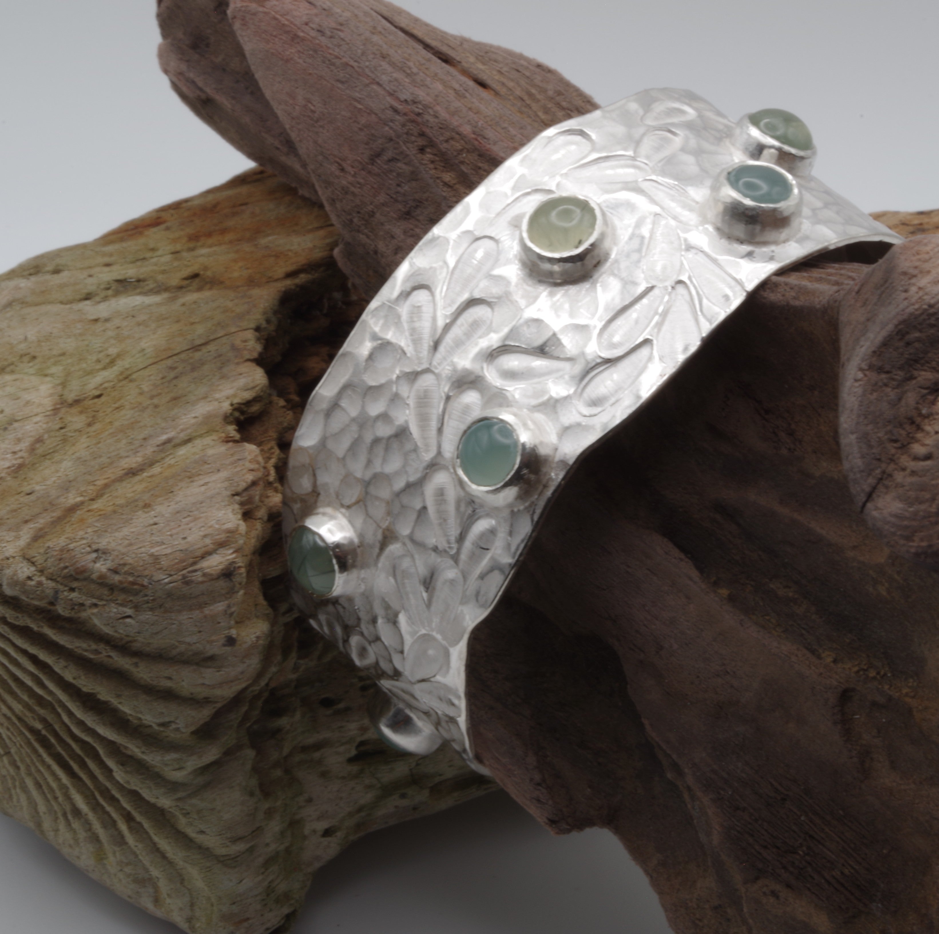 This reclaimed Sterling Silver forged and stamped bangle with rutilated quartz and chalcedony cabochons with flowing waterweed design is inspired by Kent Chalk Streams. It is hand stamped using tools made by me from vintage reclaimed tool steel.