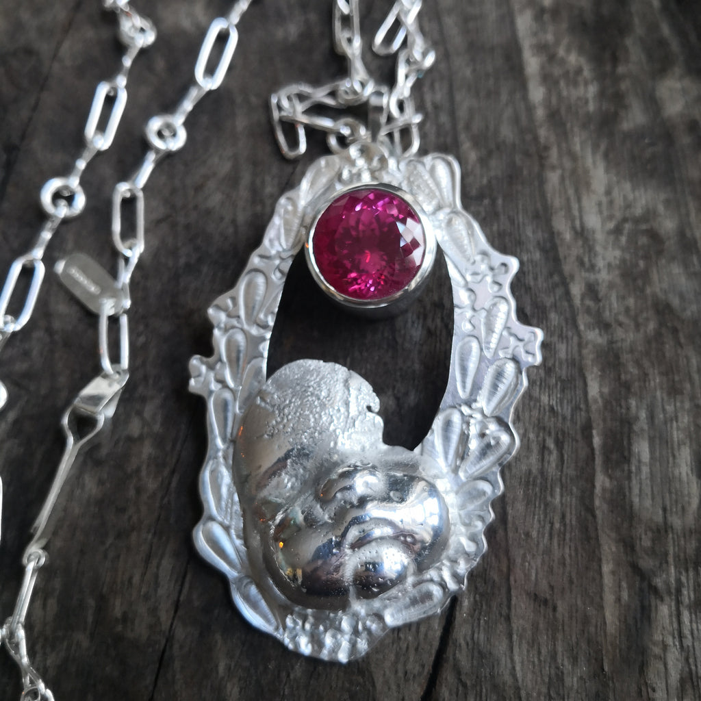 "Cherub thinks in pink sparkles" - Cherub pendant with large pink sapphire
