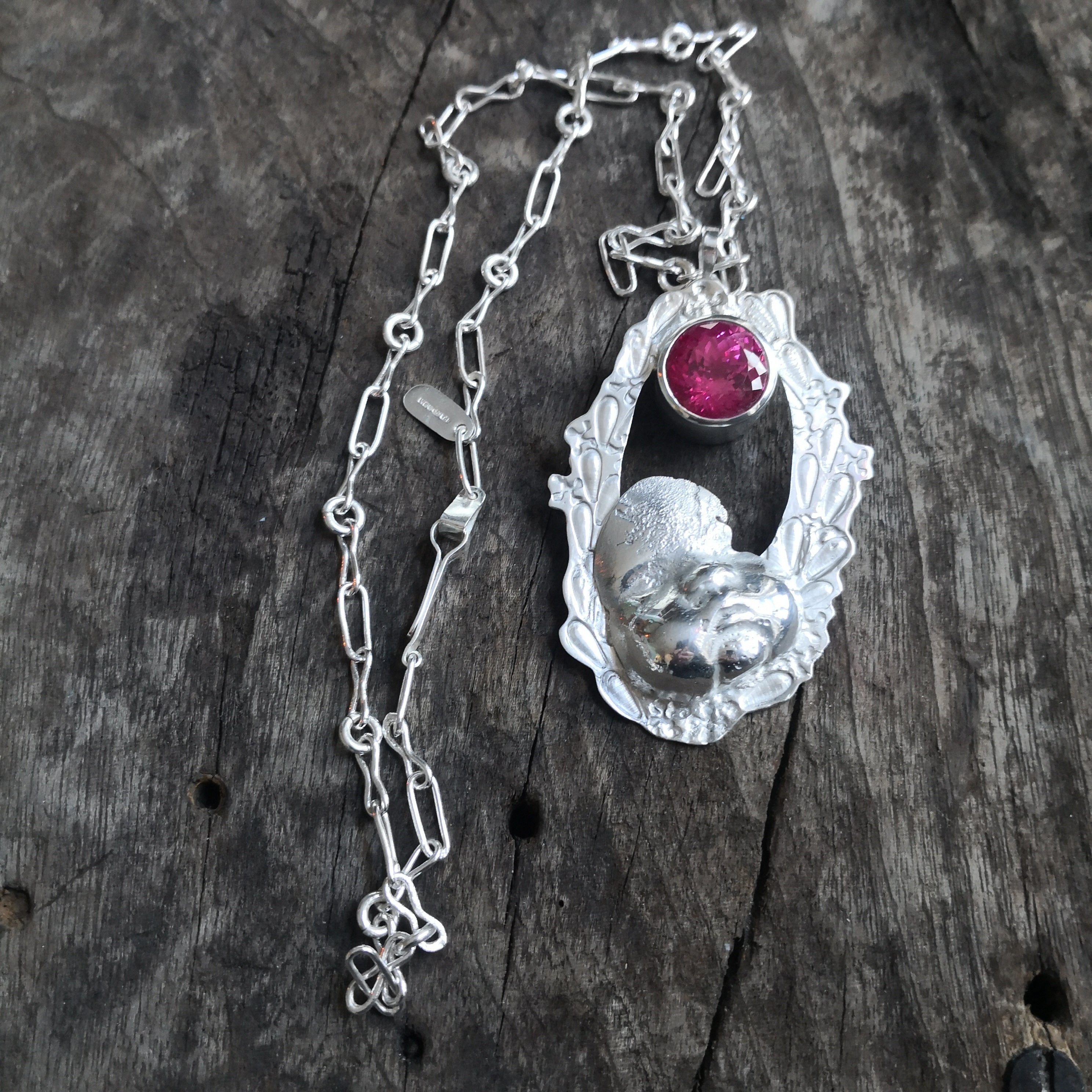 "Cherub thinks in pink sparkles" - Cherub pendant with large pink sapphire